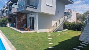 a house with a spiral staircase in the yard at Blue view in Skala Rachoniou