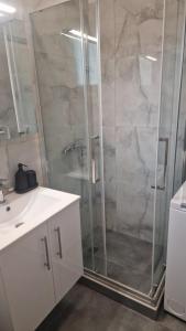 a shower with a glass door in a bathroom at Blue view in Skala Rachoniou