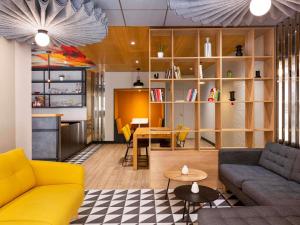 a living room with a couch and a table at Ibis Marseille Centre Prefecture in Marseille