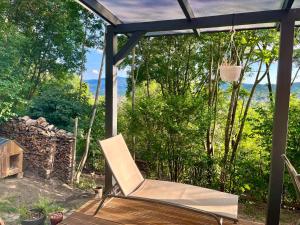 a white chair sitting on a porch with a view at Berkenye 2621 in Kismaros
