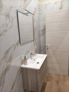 a bathroom with a sink and a mirror at Domus Rhegium in Reggio di Calabria +8 photos