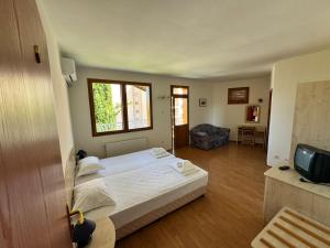 a bedroom with a bed and a living room at Orpheus Hotel in Varna City