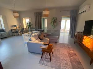 a living room with a couch and a tv at Casa da Âncora in Viana do Castelo
