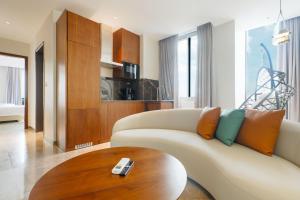 a living room with a couch and a wooden table at Abantu Hotel in Dar es Salaam