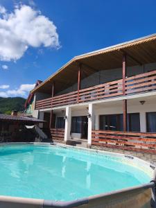 a large swimming pool in front of a building at Vila Smeu in Dubova