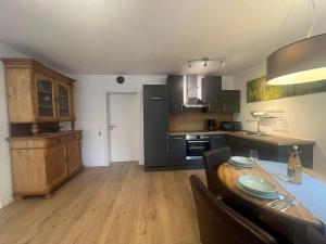 a kitchen with a table and a dining room at Ferienwohnung Haus Hahnfelsblick in Erfweiler +7 photos