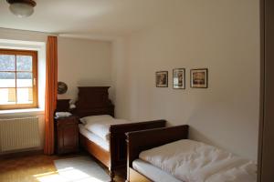 a bedroom with two beds and a window at Benediktinerstift Michaelbeuern in Michaelbeuern