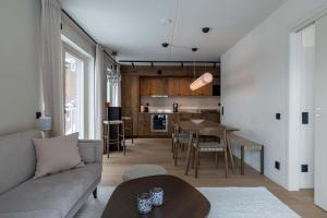 a living room and kitchen with a couch and a table at Twintip Apartments in Åre