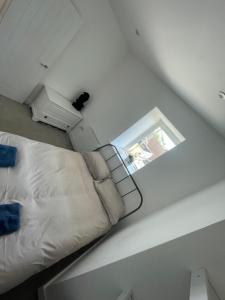 a room with a bed and a mirror on the wall at 1 Marine House in Penzance