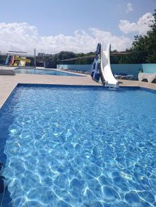 a swimming pool with a water slide in a resort at Vel-Mer Lefke in Ayios Nikolaos