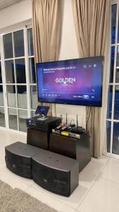 a living room with a large screen television and a keyboard at Riverview Bungalow in Cameron Highlands in Tanah Rata +54 photos