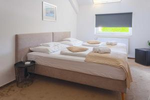 a bedroom with a large bed with two pillows on it at OÁZIS Hotel*** in Nagykanizsa