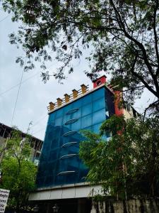 a tall blue building with a bunch of goldcaps on it at Wakad Executive in Méribel Village