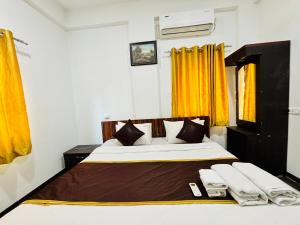 a bedroom with a large bed with yellow curtains at Wakad Executive in Méribel Village