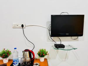 a flat screen tv hanging on a wall with a table at Wakad Executive in Méribel Village