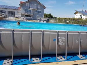 a person swimming in a swimming pool at Double room 75 sqm between Augsburg and Munich in Wiedergeltingen