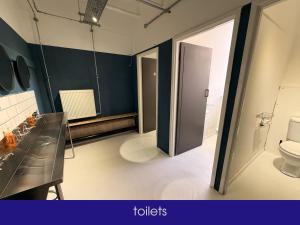a bathroom with a toilet and a sink at NQnap in Manchester +13 photos