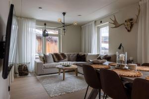 a living room with a couch and a table at Twintip Apartments in Åre