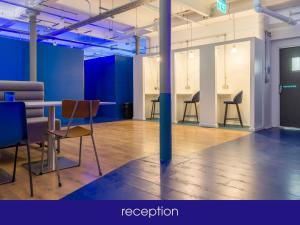 a room with chairs and a table and a pole at NQnap in Manchester