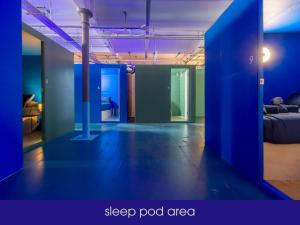 a room with a bed and a blue wall at NQnap in Manchester