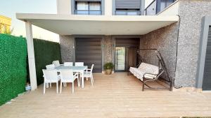 a patio with a table and chairs and a building at Villa Guru Efeler in Didim