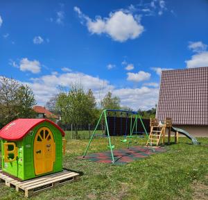 a playground with a play structure and a swing at Plai cu dor - Brebu in Brebu Mînăstirei