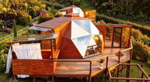 a house shaped like a boat on a deck at Imperios Glamping in Silvania