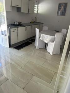 a kitchen with a table and a table and chairs at Chez Ava in Salazie