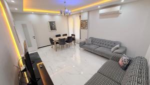 a living room with a couch and a dining room at Villa Guru Efeler in Didim