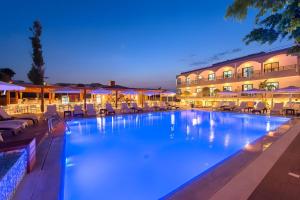 a large swimming pool in front of a hotel at Sunny Days Hotel in Ixia
