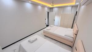 a small room with a bed and two chairs at Villa Guru Efeler in Didim +21 photos