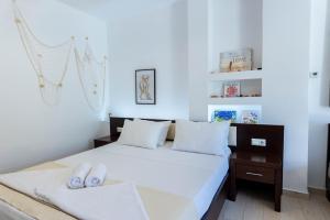 a bedroom with a bed with two white pillows at Alex port view apartments in Syvota