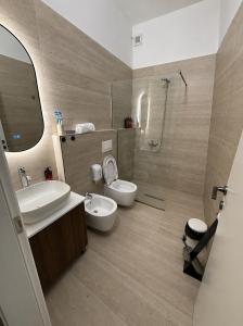 a bathroom with a sink and a toilet and a shower at Selez Aparthotel & Residence in Durrës +23 photos