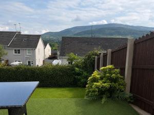 a backyard with a fence and green grass at The Cloverhill House in Mullaghbane +7 photos