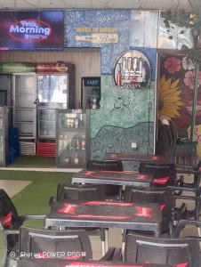a restaurant with tables and chairs in a room at Extramile Hotel and Lounge in Ibadan