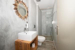 a bathroom with a sink and a toilet and a mirror at Naya in Kissamos +44 photos