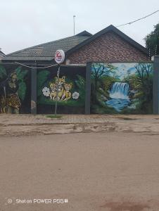 a mural on the side of a building at Extramile Hotel and Lounge in Ibadan