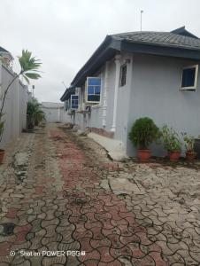 a house with a cobblestone driveway in front of a house at Extramile Hotel and Lounge in Ibadan