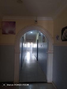 an empty hallway with an archway in a building at Extramile Hotel and Lounge in Ibadan