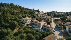 an aerial view of a village with houses on a hill at Alex port view apartments in Syvota