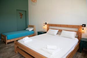a bedroom with two beds and a blue couch at Naya in Kissamos