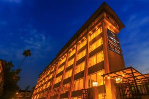 a large building with a lot of windows at night at Central Courtyard Boutique Hotel in Siliguri