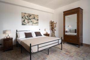 a bedroom with a bed and a dresser and a mirror at Oasi Orange Villa with Jacuzzi in Paterno +38 photos