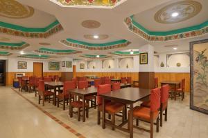 a dining room with tables and chairs and ceilings at Central Hill Resort The Mall Road in Gangtok