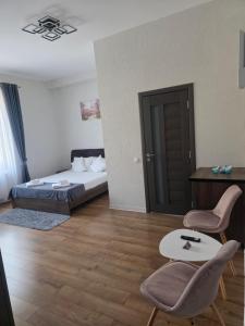 a bedroom with a bed and a table and chairs at Turmhaus Hermannstadt in Sibiu