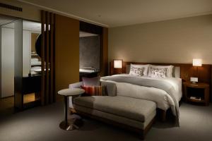 a hotel room with a bed and a chair at Keio Plaza Hotel Tokyo in Tokyo