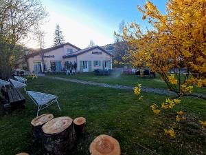 a yard with a house and a group of logs at Gite des Monges in Authon +15 photos