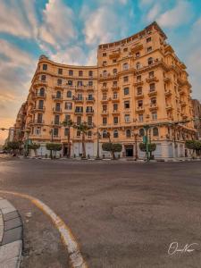 a large building on the side of a street at suites in cairo downtown in Cairo
