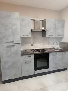 a kitchen with stainless steel appliances and a stove at Terraforte Luxury Suite in Fisciano