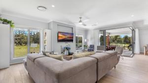 a large living room with a large couch at Kokoon in Pokolbin